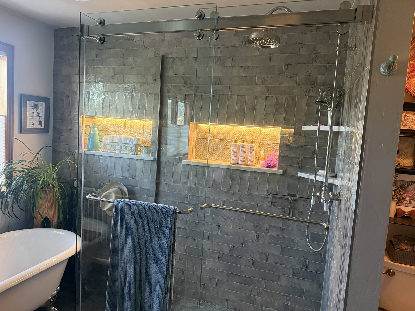 Primary bathroom shower with accent lighting